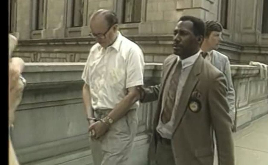A video still of John List handcuffed on his way to court. 