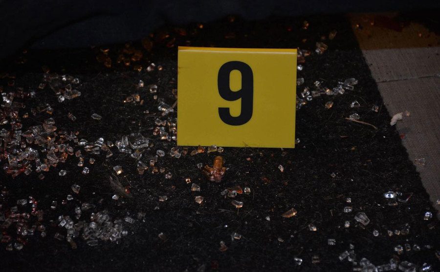 A photo of broken glass tagged as evidence in the crime scene.