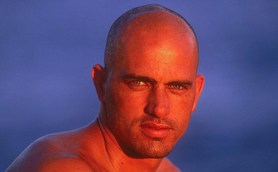 A portrait of Kelly Slater by the beach.