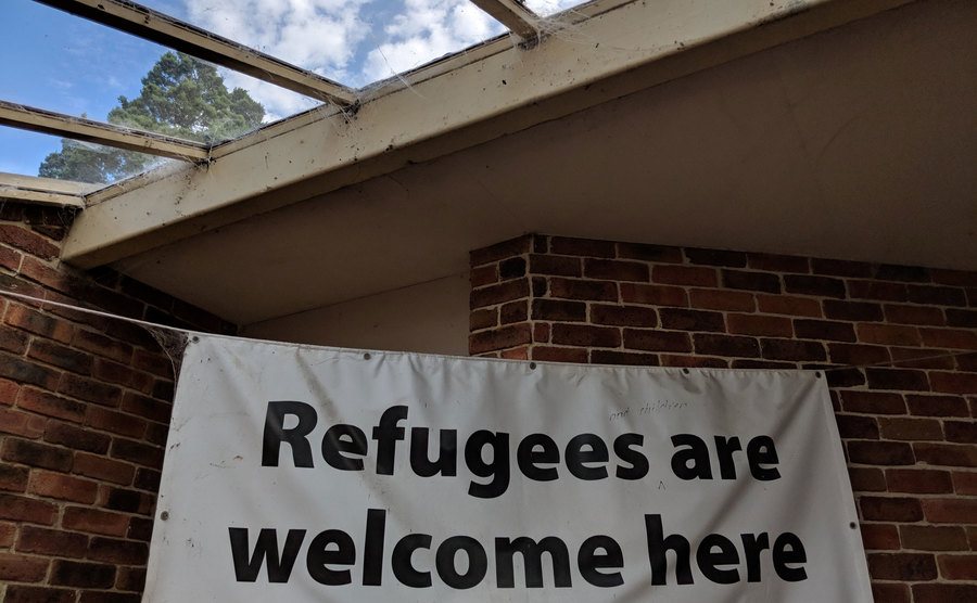 A photo of a “Refugees are welcome here” notice outside a church.