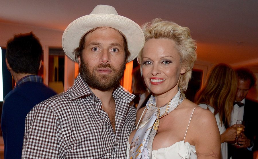Rick Salomon and Pamela Anderson attend an event.