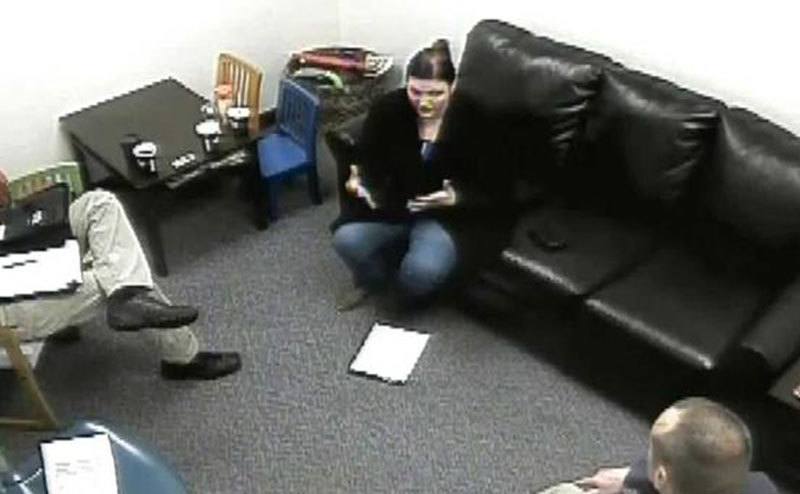A surveillance photo of Michelle at the interrogation room.
