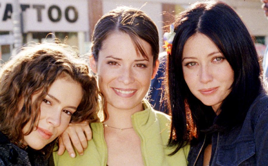A photo of Alyssa Milano, Holly Marie Combs, and Shannen Doherty behind the scenes.