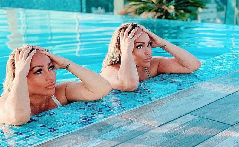 Darcey and Stacey pose together in the pool. 