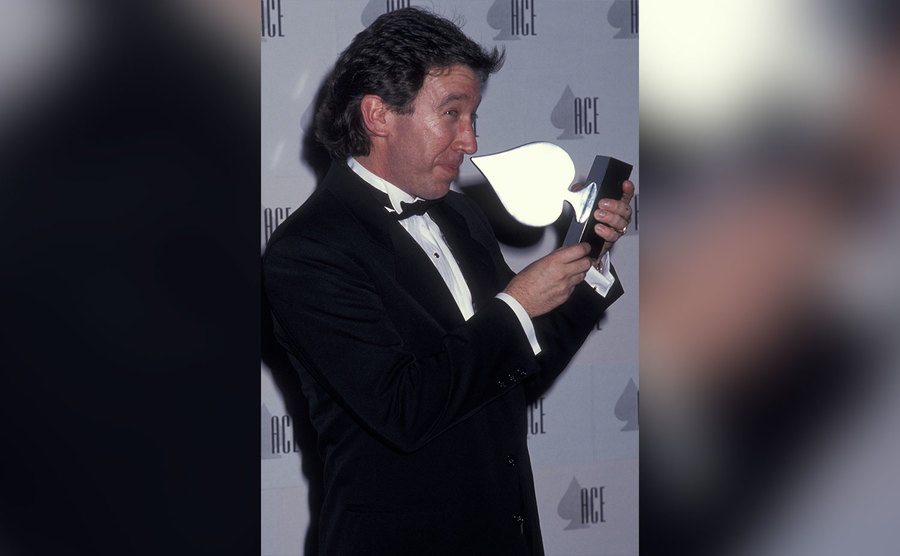 Tim Allen jokingly picked his nose with an award. 