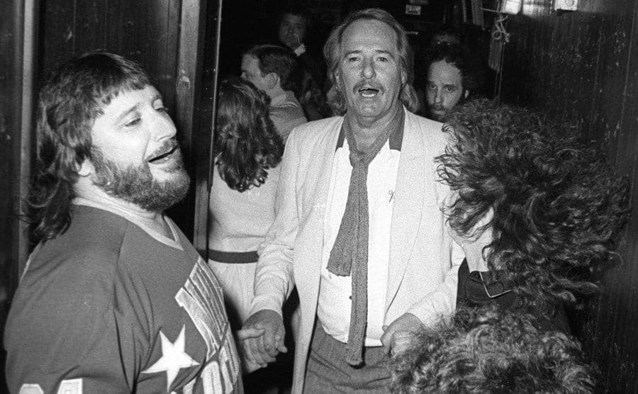 Denny Doherty and John Phillips attend a party after a show.
