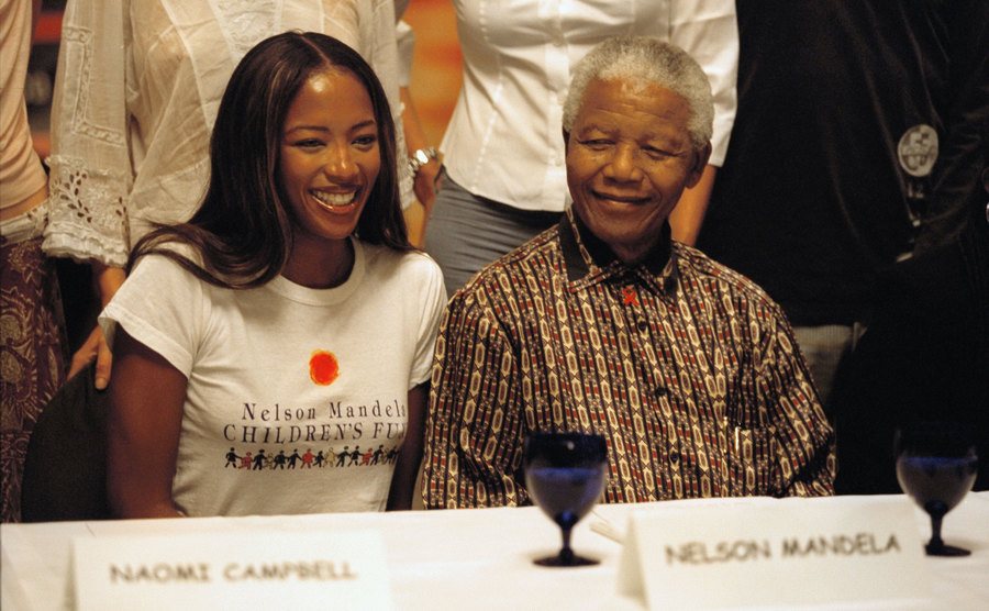 Naomi Campbell and Nelson Mandela speak at a press conference. 