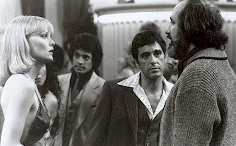 Michelle Pfeiffer, Al Pacino, and Brian De Palma on the set of Scarface. 