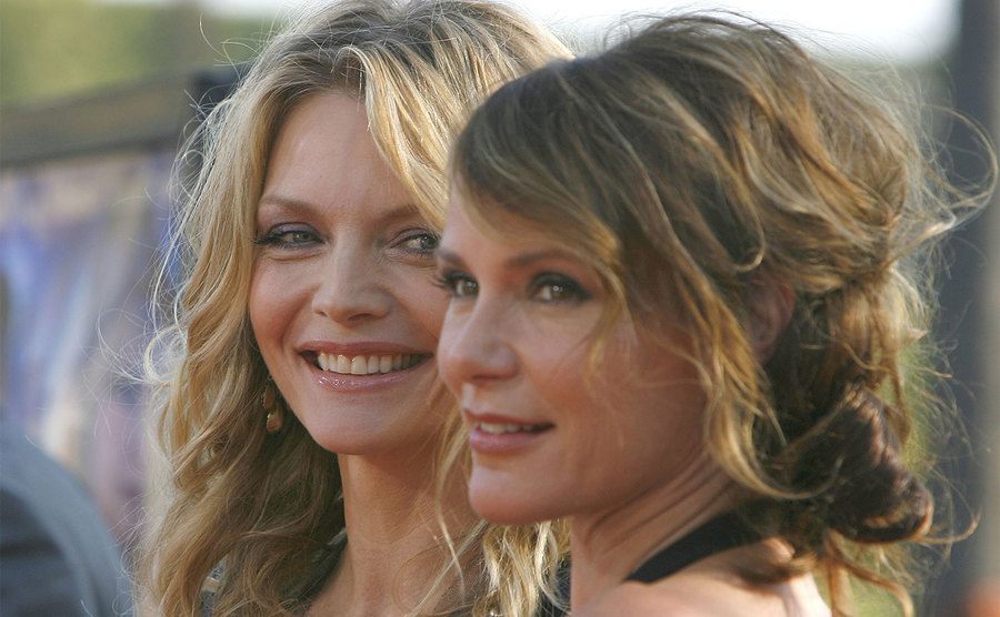 Michelle Pfeiffer and her sister, Dedee Pfeiffer arrive at a premiere. 
