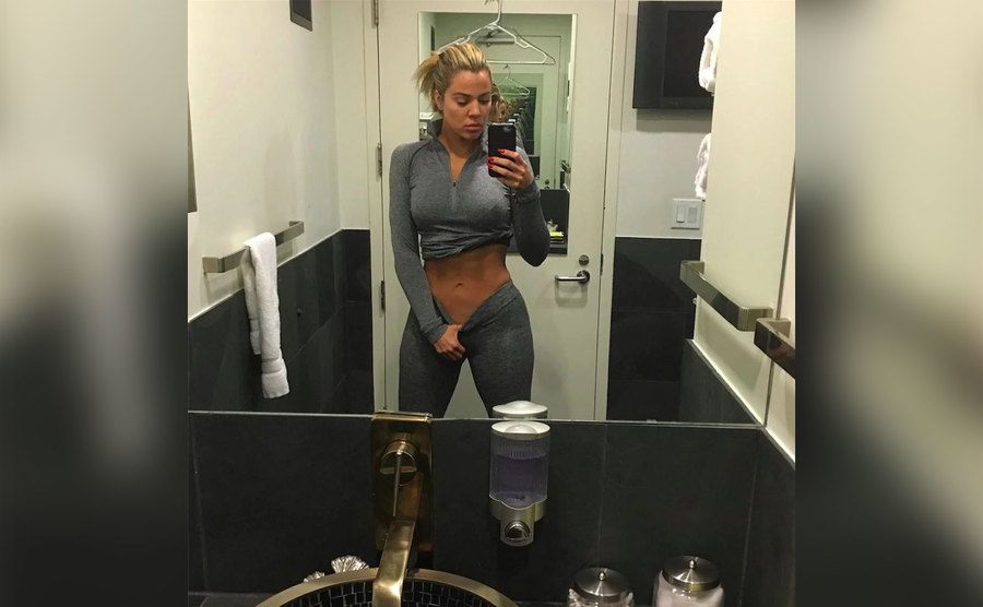 Khloe takes a mirror selfie of her trim body. 
