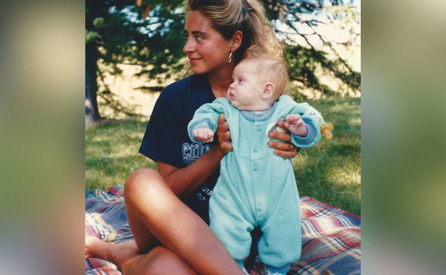 Chiara Ferragni, as a baby, is being held by her mother. 