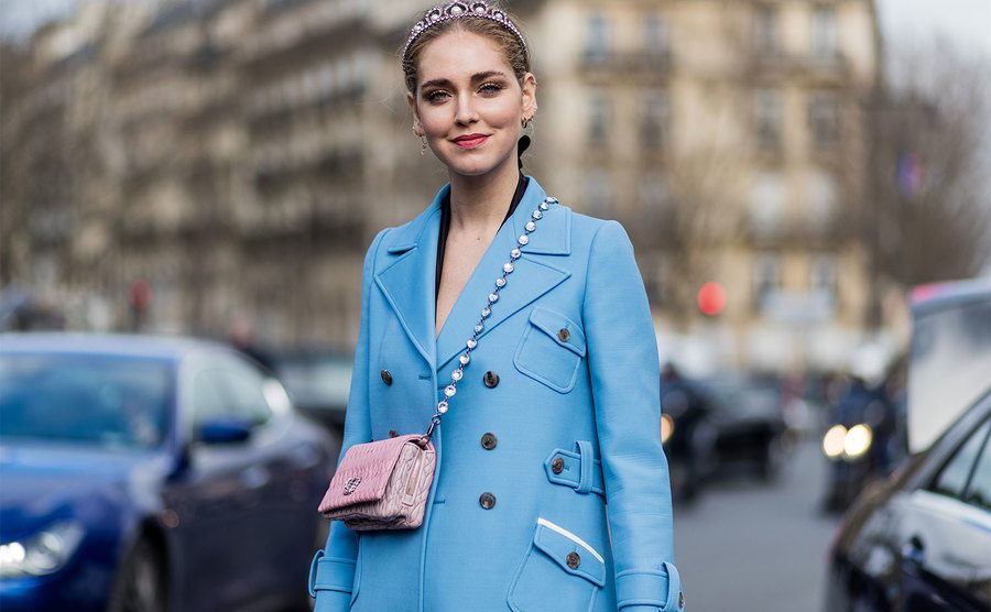Chiara Ferragni wearing a blue coat, platform shoes, Chanel mini bag in Paris. 
