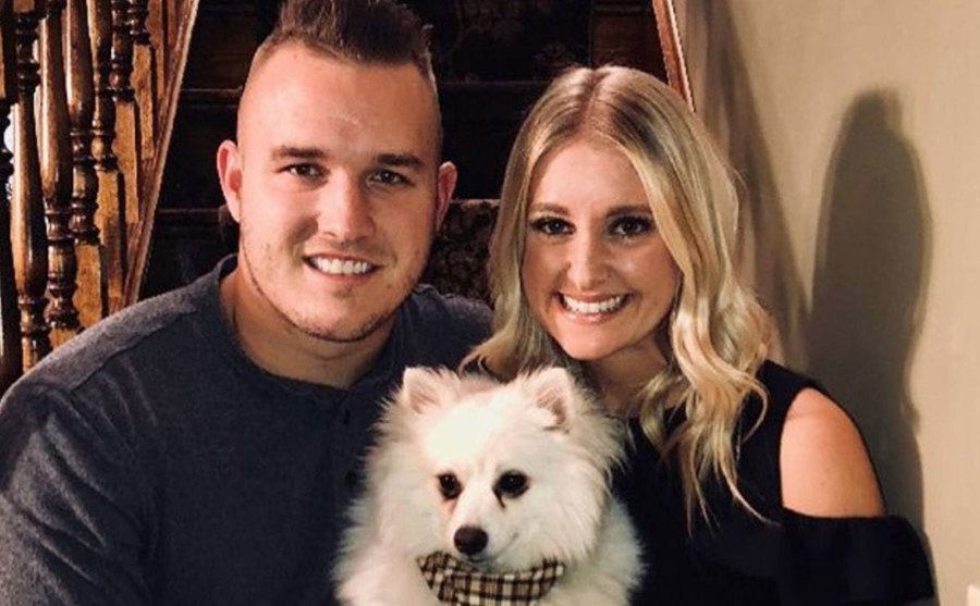 Jessica Cox and Mike Trout pose with their dog at home. 