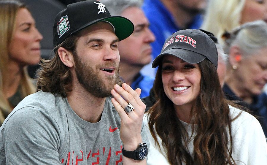 Bryce Harper and his wife Kayla Harper attend a game
