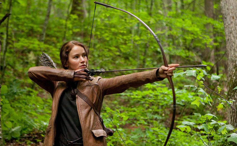 Jennifer Lawrence pulls her bow and arrow as Katniss Everdeen. 