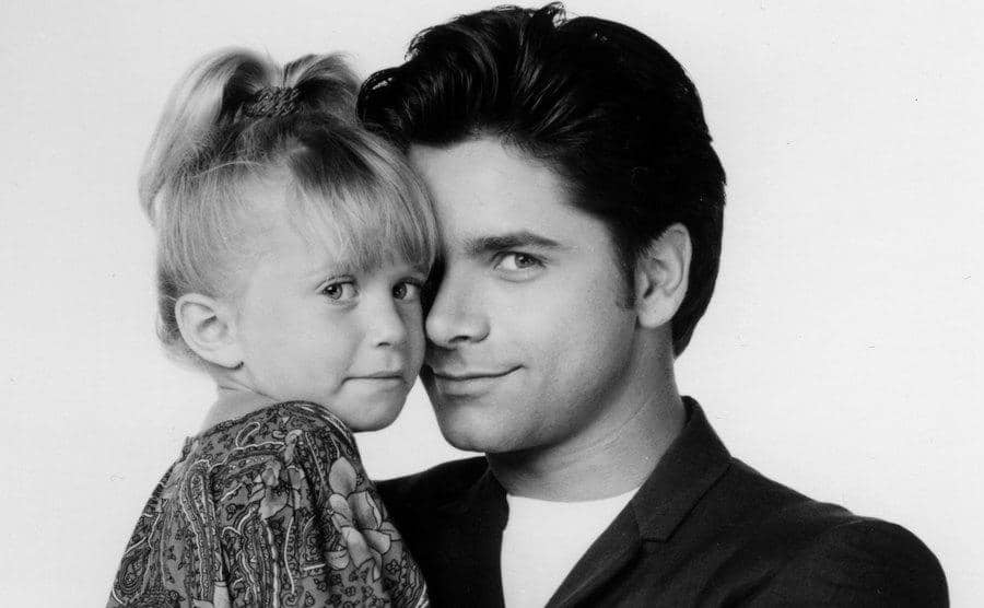 Mary-Kate Olsen and John Stamos pose in a promotional portrait of the show.
