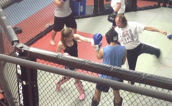 Sydney is practicing MMA in the gym. 