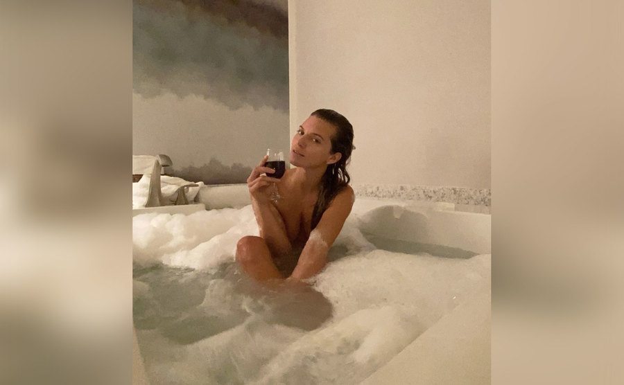 AnnaLynne McCord takes a bath with a glass of wine. 