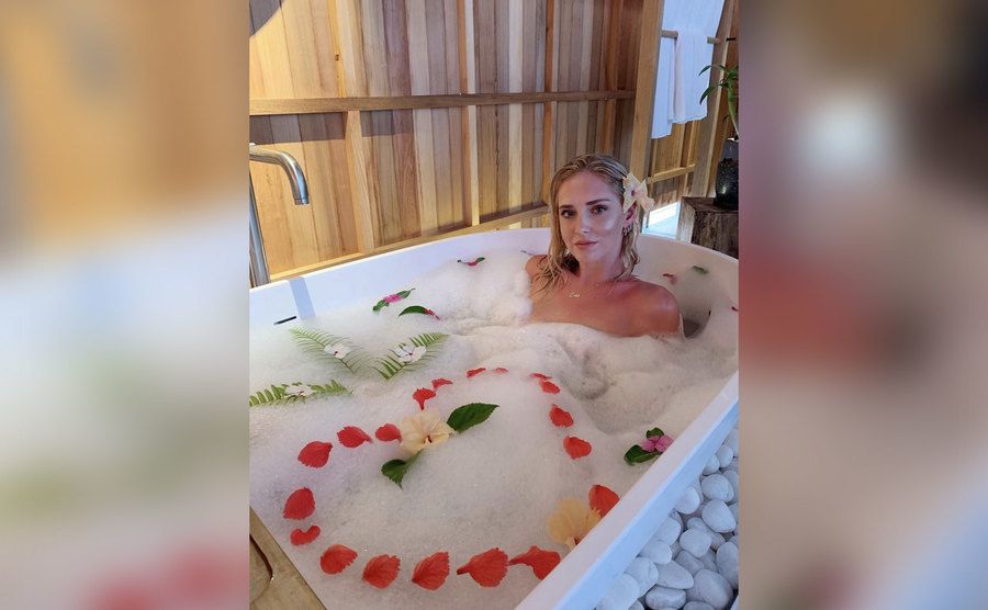 Chiara Ferragni relaxes in a tub with flower petals. 