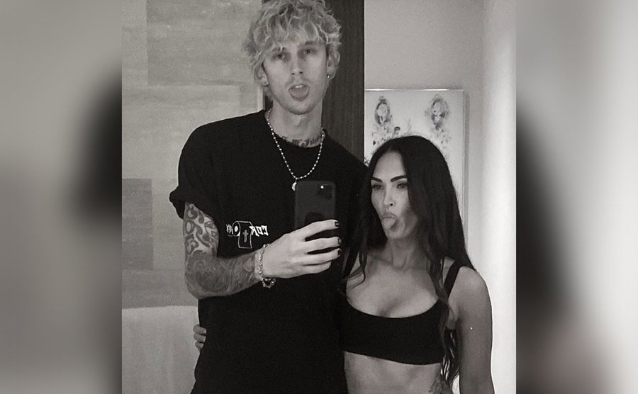 MGK and Megan Fox stick their tongues out for a mirror selfie. 