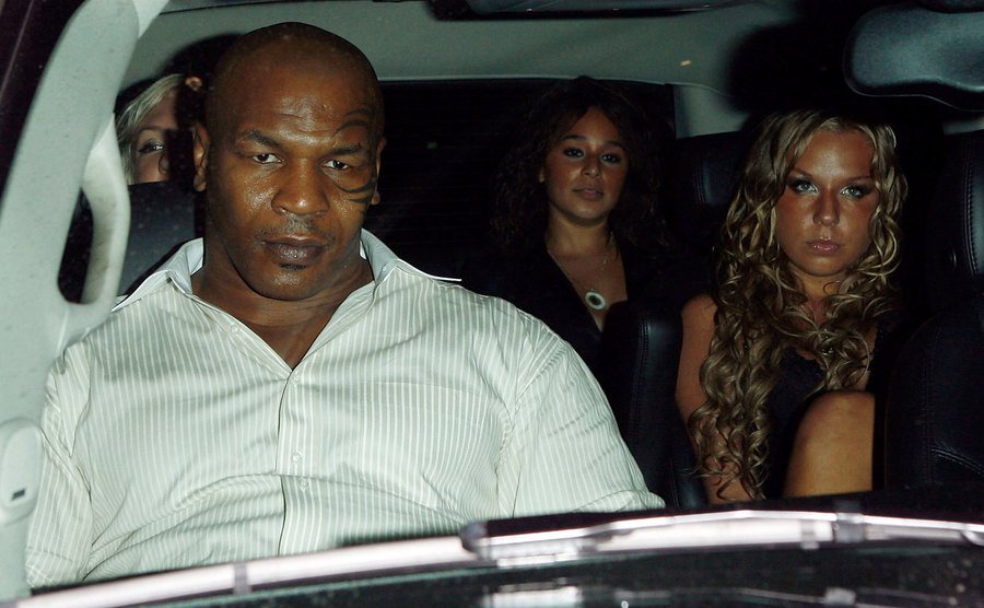 A photo of Tyson riding a car with friends at night.