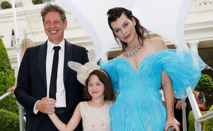 Paul W.S. Anderson and Jovovich pose with their daughter, Dashiel, during an event.