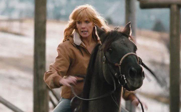 Kelly Reilly is riding horseback. 