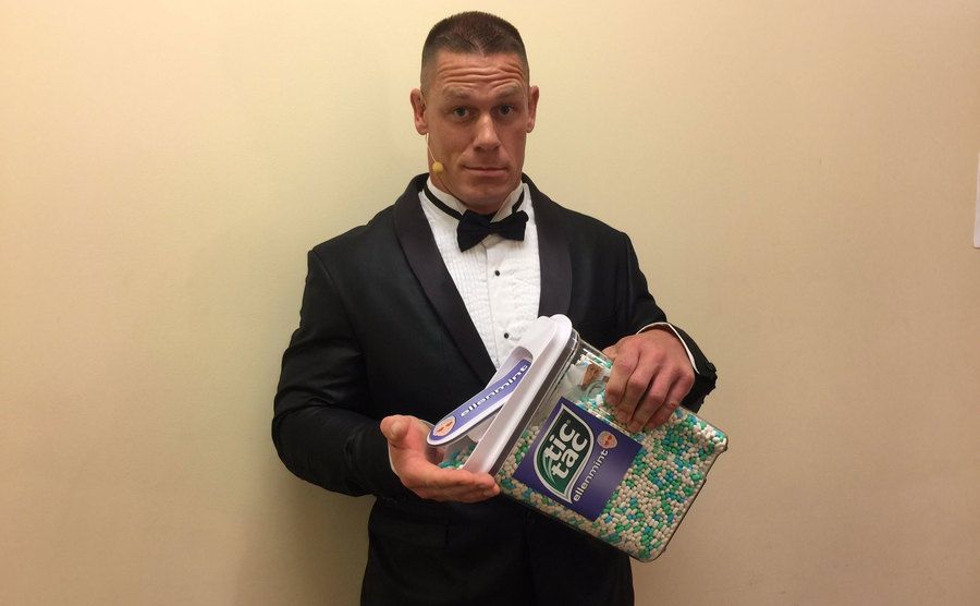 John Cena poses with a large box of Tic Tacs. 