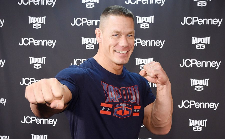 John Cena poses for the press at an event. 