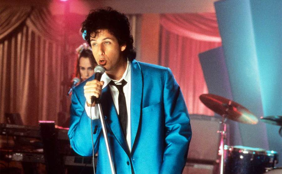 Adam Sandler sings in a scene from the film 'The Wedding Singer’ 