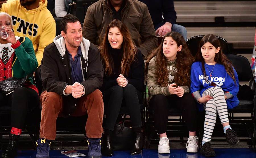 Adam Sandler and his family attend a basketball game. 