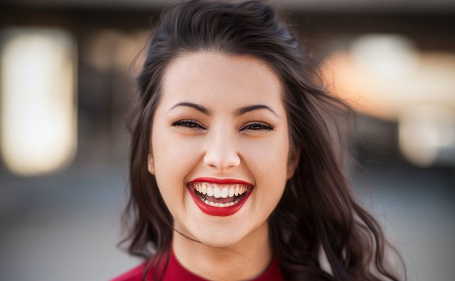 A woman is smiling in a photo. 