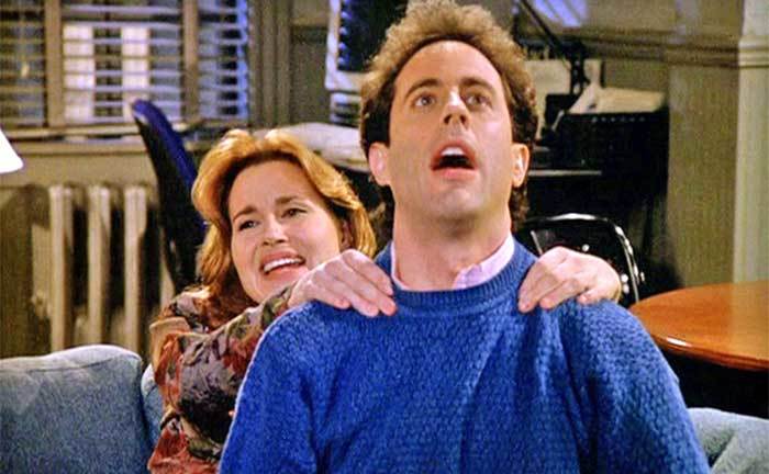 Jennifer Coolidge is giving Jerry Seinfeld a massage in a still from the TV show. 