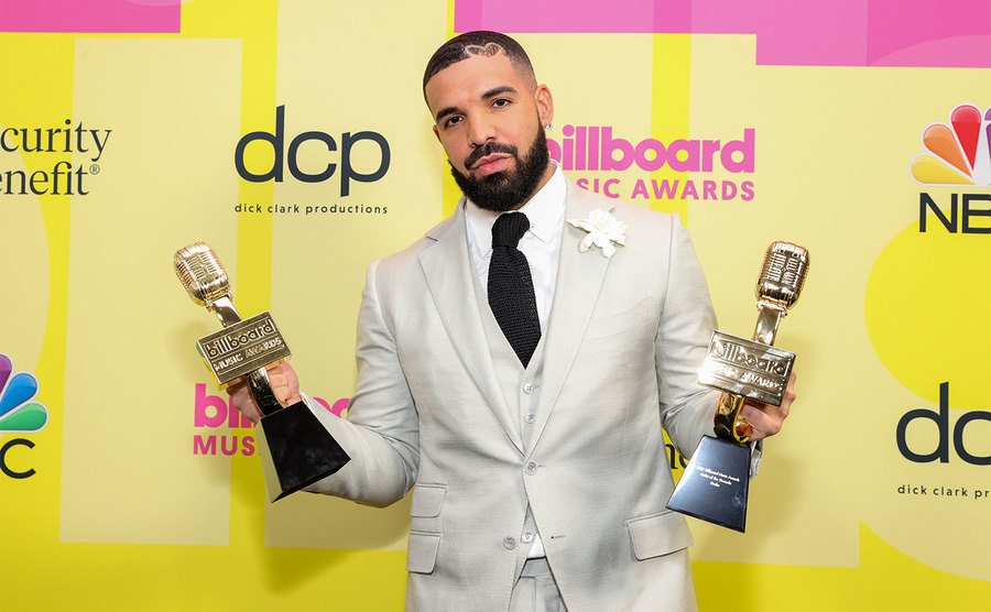 Drake poses with his awards. 