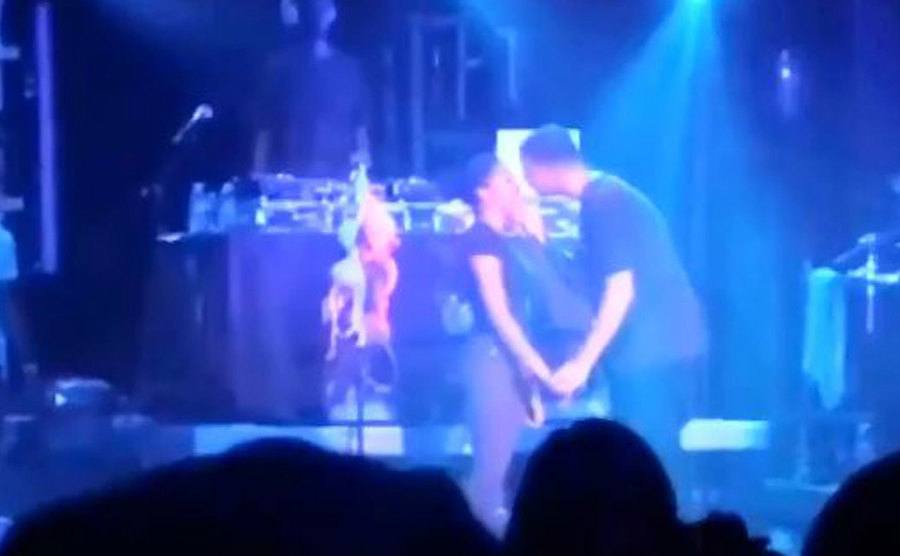 Drake leans in to kiss a fan. 