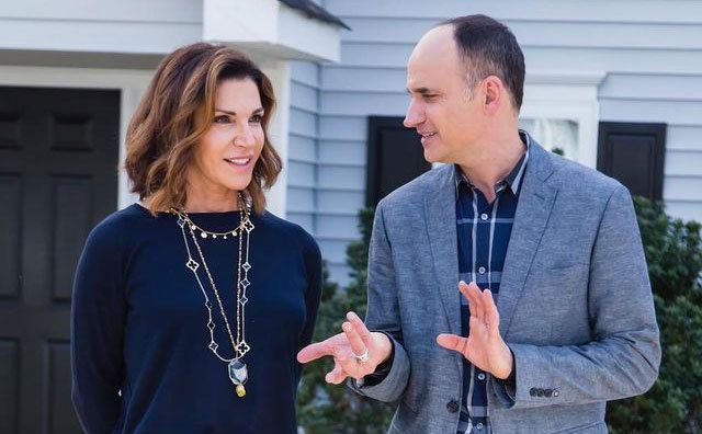 Hilary Farr and David Visentin talk in front of a home. 