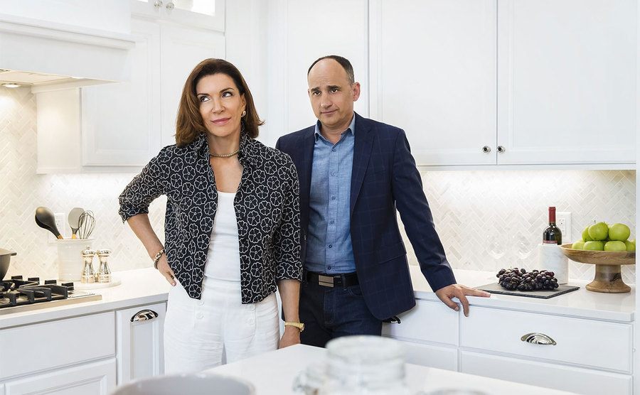 Hilary Farr and David Visentin look at a kitchen. 