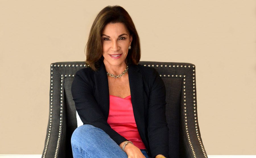 Hilary Farr poses in a chair. 